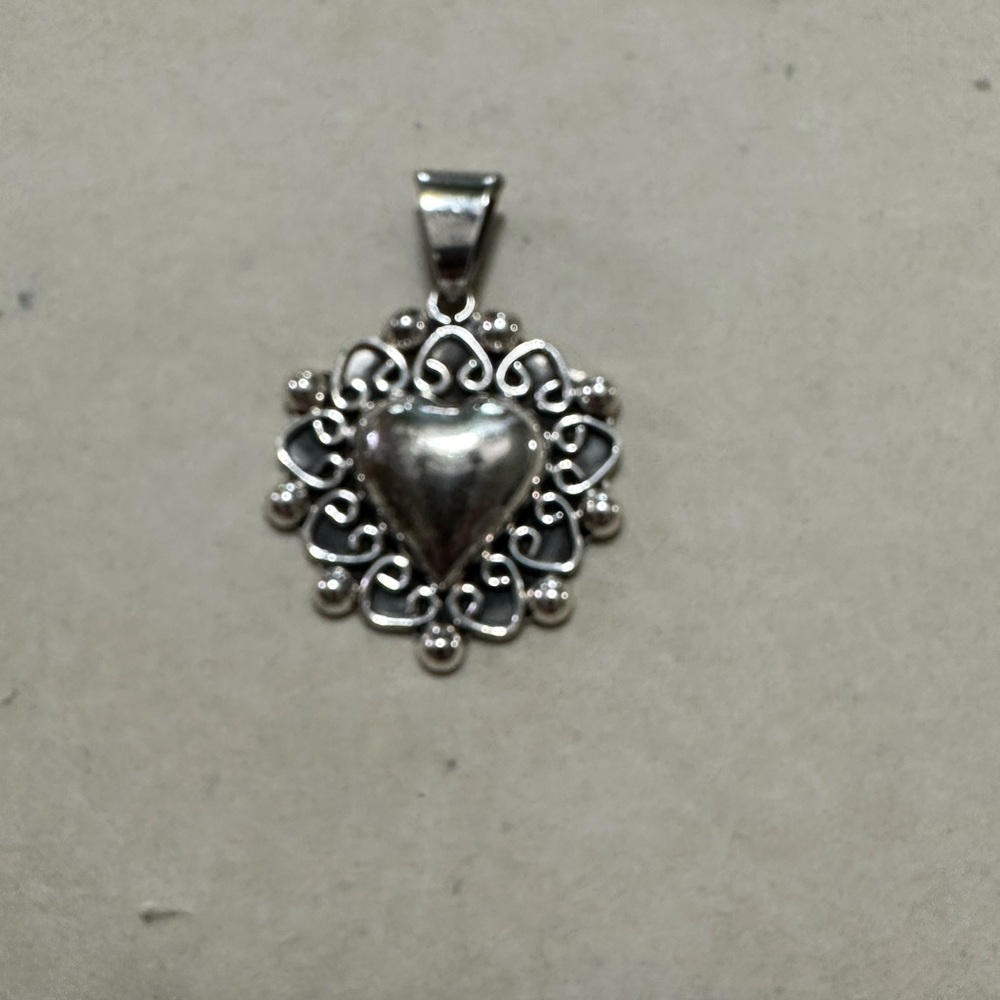 Vintage Taxco Mexico sterling silver heart shaped pendant.